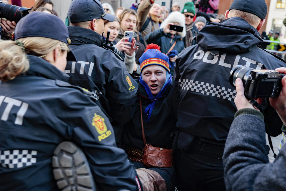 Police officers carry away a demonstrator during a protest against a wind farm activists say hinders the rights of the Sami Indigenous people, in Oslo, Thursday, March 2, 2023. (Alf Simensen/NTB Scanpix via AP)