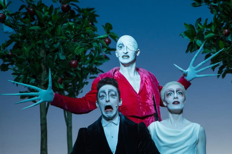 Actors Fabian Stromberger in the role of Faust, Christopher Nell (background) as Mephistopheles and Anna von Haebler as Helena play a scene of "Faust I and II" during a rehearsal at the Berliner Ensemble theatre in Berlin on April 20, 2015