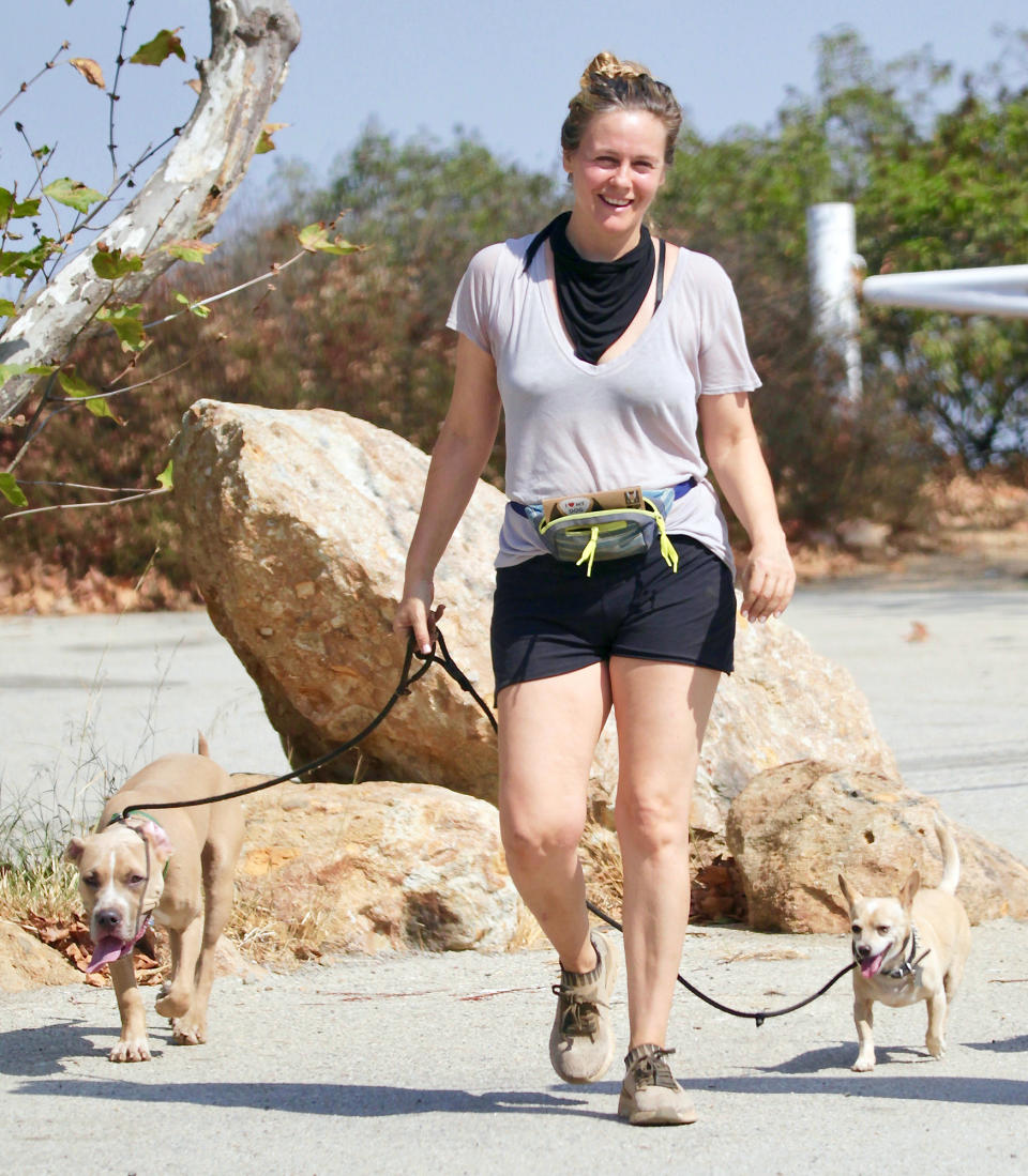 <p>Alicia Silverstone is all smiles while hiking with her two dogs on Monday in L.A. </p>