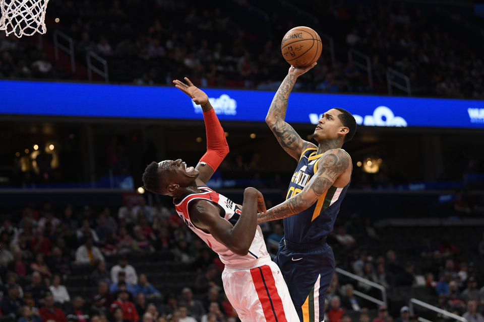 Utah Jazz guard Jordan Clarkson, right, fouls Washington Wizards guard Isaac Bonga, left, during the first half of an NBA basketball game, Sunday, Jan. 12, 2020, in Washington. (AP Photo/Nick Wass)