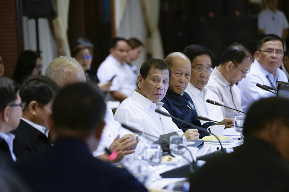 In this Tuesday, Jan. 7, 2020, photo provided by the Malacanang Presidential Photographers Division, Philippine President Rodrigo Duterte, center, presides during the Joint Armed Forces of the Philippines-Philippine National Police (AFP-PNP) Command Conference at the Malacanang presidential palace in Manila, Philippines. The Philippine government has ordered the mandatory evacuation of Filipino workers from Iraq and is sending a coast guard vessel to the Middle East to rapidly ferry its citizens to safety in case hostilities between the United States and Iran worsen, officials said Wednesday. (King Rodriguez/Malacanang Presidential Photographers Division via AP)