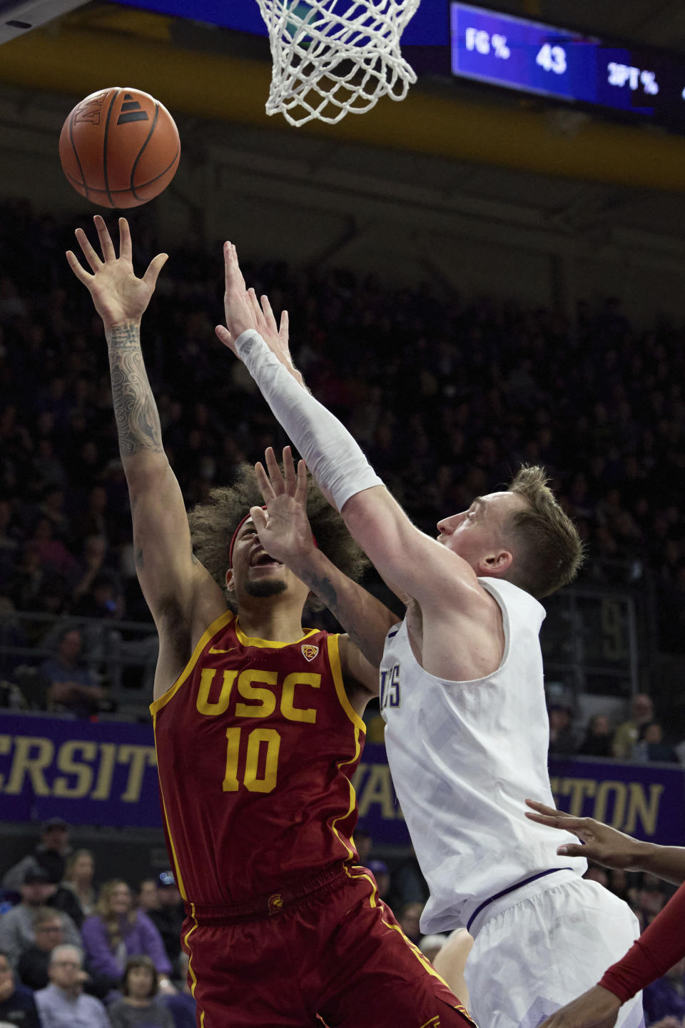 Southern California forward DJ Rodman (10) shoots with Washington forward Moses Wood, right, defending during the second half an NCAA college basketball game, Saturday, March 2, 2024, in Seattle. (AP Photo/John Froschauer)