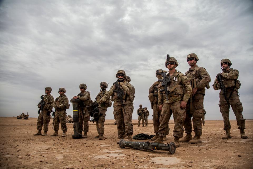 American soldiers stand during a joint exercise with Syrian Democratic Forces at the countryside of Deir Ezzor in northeastern Syria, Wednesday, Dec. 8, 2021.