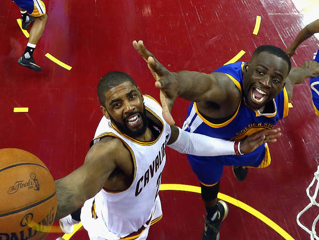 Gravity prevents Draymond Green from blocking Kyrie Irving’s layup. (Getty Images)