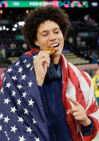 <p>Tnani Badreddine/DeFodi Images via Getty</p> Brittney Griner with her gold medal following 2024 Paris Olympics