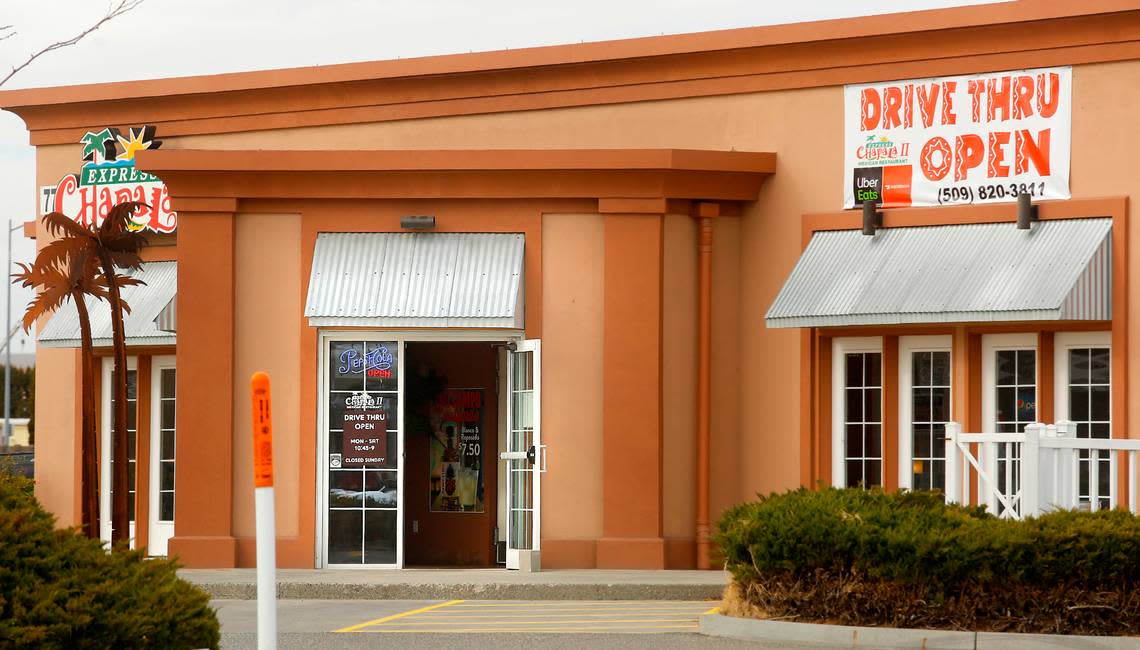 The front door of the main entrance is propped open at the Chapala Express II Mexican Restaurant on the corner of Columbia Center Boulevard and West Clearwater Avenue in Kennewick. A banner at the business , not visible, also advertises for dining room seating.