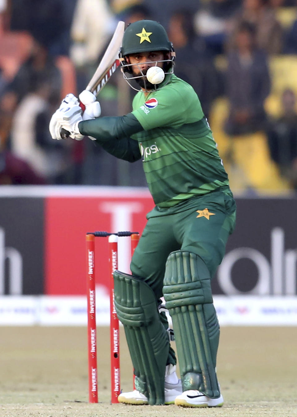 Pakistan batsman Mohammad Hafeez plays a shot during the second T20 cricket match against Bangladesh at Gaddafi stadium, in Lahore, Pakistan, Saturday, Jan. 25, 2020. (AP Photo/K.M. Chaudary)