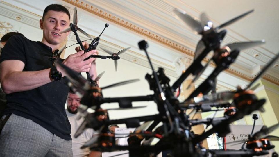 A Ukrainian serviceman in Lviv holds a donated DJI Mavic drone