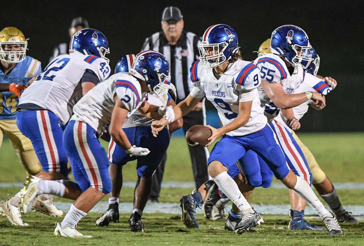 Pickens sophomore Landon Pace hands off to Pickens senior Jaden Jackson during the second quarter at DW Daniel High in Central, S.C. Friday, September 16, 2022.