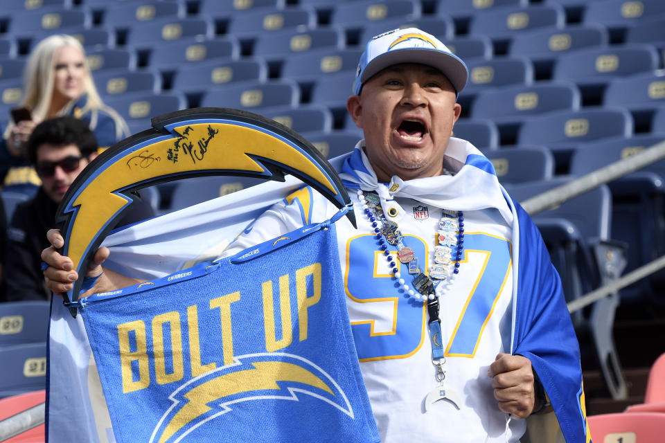 DENVER, CO - NOVEMBER 28: A Chargers fan cheers as players warm up for the NFL game between the Los Angeles Chargers and the Denver Broncos on November 28, 2021, at Empower Field at Mile High in Denver, Colorado. (Photo by Michael Allio/Icon Sportswire via Getty Images)