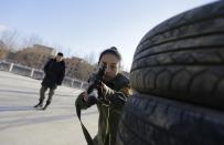 A student aims a replica 95 semi-automatic rifle during training at the Tianjiao Special Guard/Security Consultant training camp on the outskirts of Beijing December 11, 2013. Former Chinese soldier Chen Yongqing has big ambitions for his bodyguard training school Tianjiao, which he says is China's first professional academy to train former soldiers and others as personal security guards. Chen charges 500,000 yuan ($82,400) a year for each protector as China's rich and famous look to bolster their safety and sense of importance. Picture taken December 11, 2013. REUTERS/Jason Lee (CHINA - Tags: BUSINESS SOCIETY) ATTENTION EDITORS: PICTURE 02 OF 26 FOR PACKAGE 'CHINA'S BODYGUARD SCHOOL' TO FIND ALL IMAGES SEARCH 'TIANJIAO'