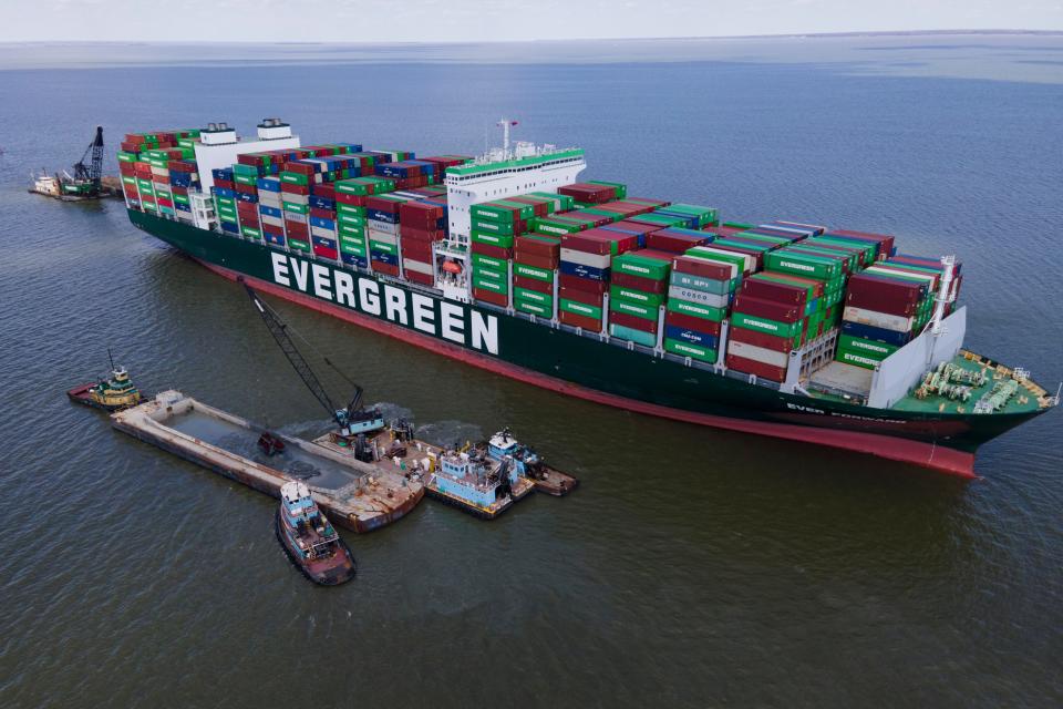 Crews dredge near the container ship Ever Forward in efforts to free it after it ran aground off the coast near Pasadena, Md., Monday, March 21, 2022.