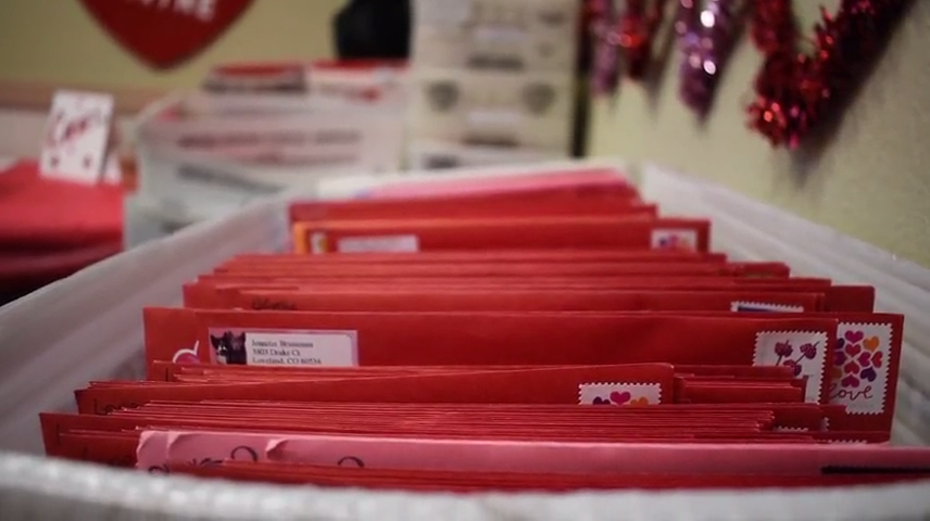 Volunteers gather at the Loveland Chamber of Commerce each February to kick off stamping for the Colorado city's valentine re-mailing program.