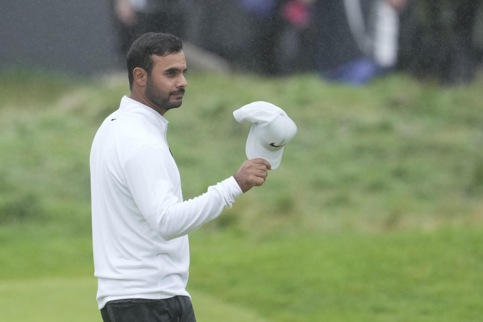India's Shubhankar Sharma acknowledges the crowd on the 18th green after completing his round during the final day of the British Open Golf Championships at the Royal Liverpool Golf Club in Hoylake, England, Sunday, July 23, 2023. (AP Photo/Kin Cheung)