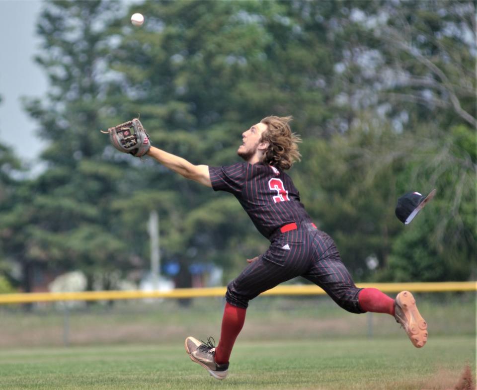 Thomas Fox tries to track down a fly ball during an MHSAA Division 4 district final between Gaylord St. Mary and Johannesburg-Lewiston on Saturday, June 3 in Gaylord, Mich.