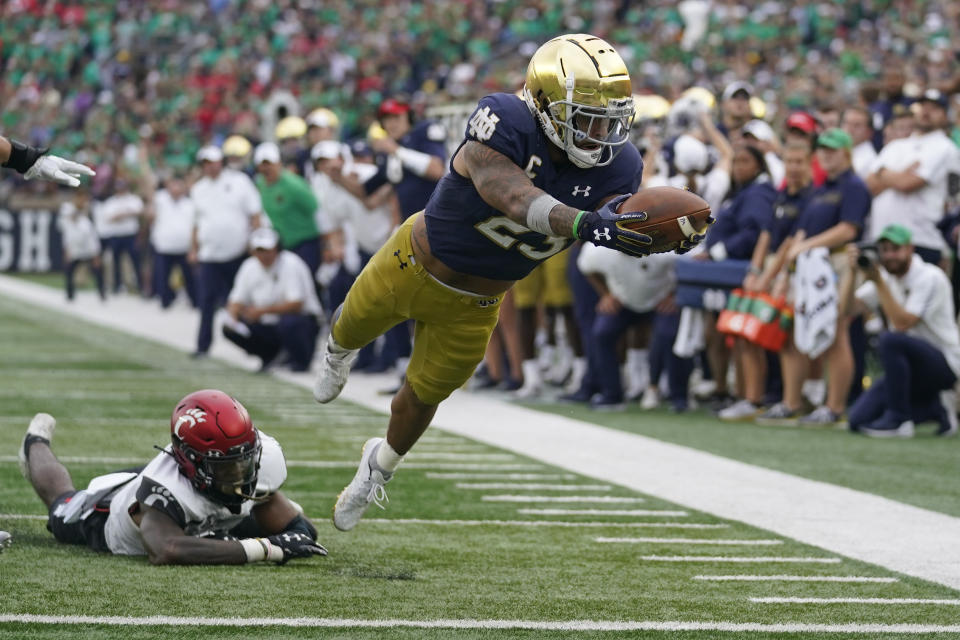 Notre Dame's Kyren Williams (23) dives into the end zone for a touchdown during the second half of an NCAA college football game against Notre Dame, Saturday, Oct. 2, 2021, in South Bend, Ind. Cincinnati won 24-13. (AP Photo/Darron Cummings)