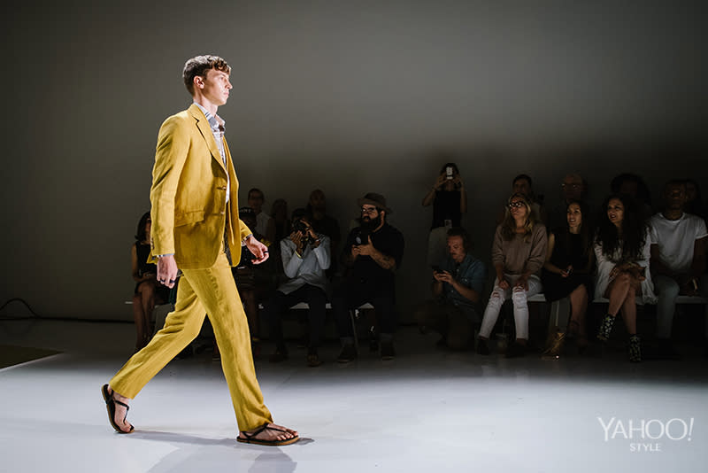 Making a bold statement in a mustard yellow linen suit.