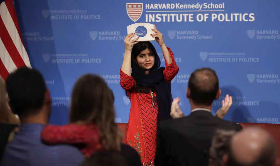 2014 Nobel Laureate Malala Yousafzai holds up the 2018 Gleitsman Activist Award as the audience applauds at the Kennedy School's Institute of Politics at Harvard University in Cambridge, Mass., Thursday, Dec. 6, 2018. (AP Photo/Charles Krupa)