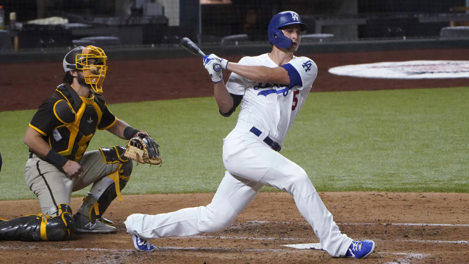 Los Angeles Dodgers' Corey Seager watches the flight of his two-RBI double off San Diego Padres starting pitcher Zach Davies during the third inning in Game 2 of a baseball National League Division Series Wednesday, Oct. 7, 2020, in Arlington, Texas. (AP Photo/Sue Ogrocki)