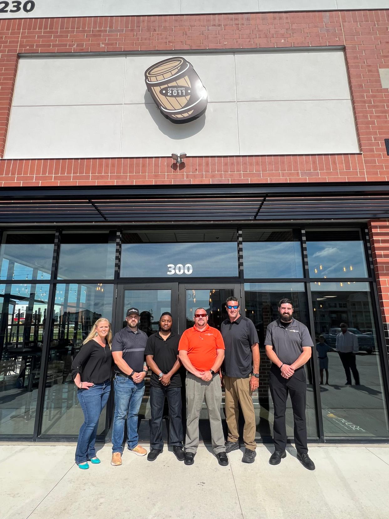 Employees at Coralville's Barrel House location, which opened last week, pose for a photo.