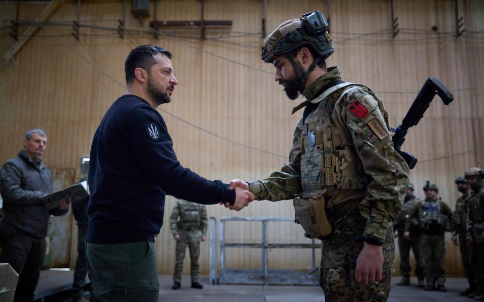 Volodymyr Zelenskiy awards a Ukrainian service member at a frontline, amid Russia's attack on Ukraine - UKRAINIAN PRESIDENTIAL PRESS SERVICE/via REUTERS