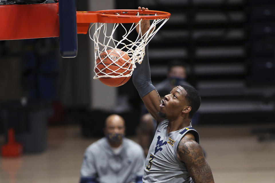 West Virginia forward Gabe Osabuohien (3) shoots against Oklahoma State during the second half of an NCAA college basketball game Saturday, March 6, 2021, in Morgantown, W.Va. (AP Photo/Kathleen Batten)