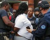 A police officer and a protester have a confrontation during an arrest after a shooting incident in St. Louis, Missouri August 19, 2015. REUTERS/Lawrence Bryant