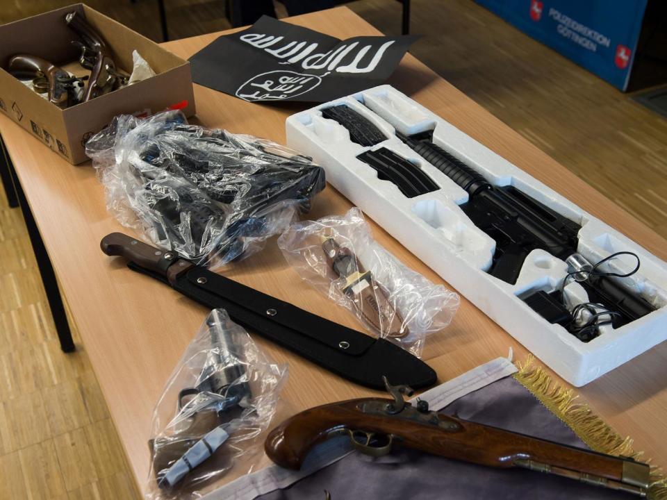 Confiscated weapons and an Isis flag seized in Gottingen, Germany, by police investigating Algerian and Nigerian men suspected of planning a terror attack (AFP/Getty Images)