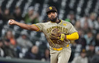 San Diego Padres third baseman Eguy Rosario throws to first base for the out on Colorado Rockies' Jake Cave to end the eighth inning of a baseball game Tuesday, April 23, 2024, in Denver. (AP Photo/David Zalubowski)