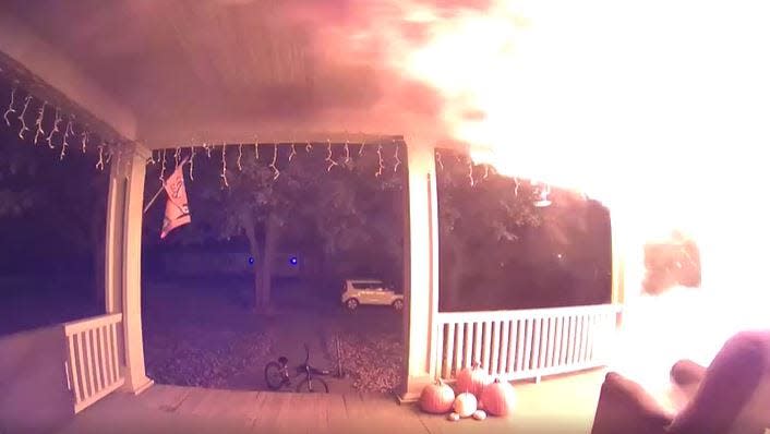 This screenshot from a Ring doorbell camera shows flames on the porch of a Red Oak house fire in October.