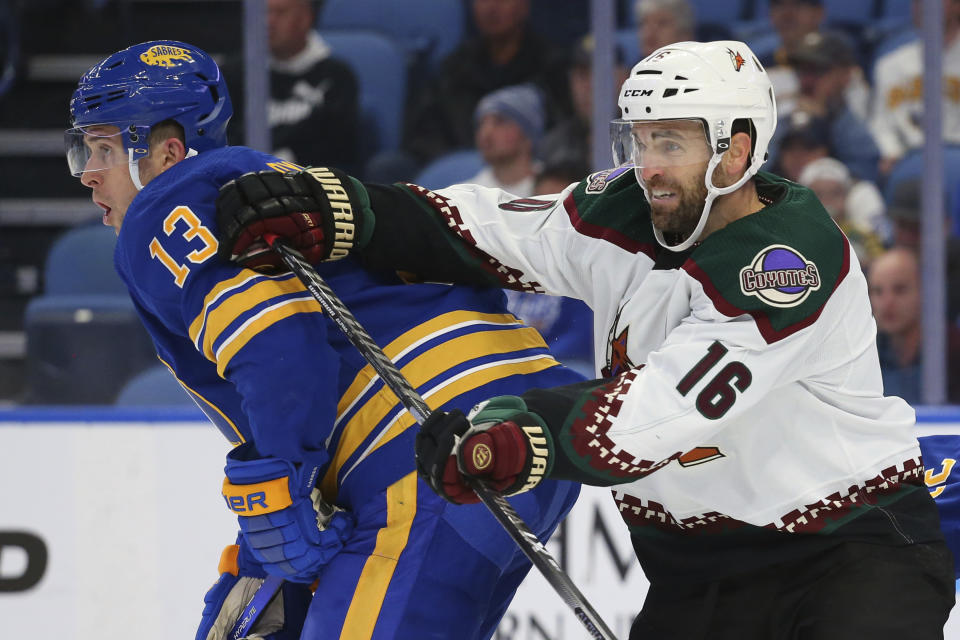 Buffalo Sabres defenseman Mark Pysyk (13) and Arizona Coyotes forward Andrew Ladd (16) battle for position during the second period of an NHL hockey game, Saturday, Oct. 16, 2021, in Buffalo, N.Y. (AP Photo/Jeffrey T. Barnes)