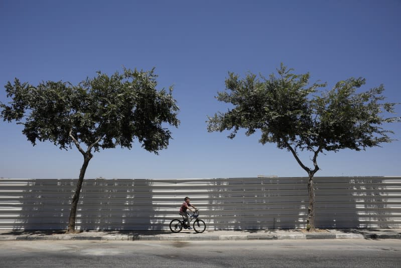 FILE PHOTO: A boy rides his bicycle in the Israeli settlement of Beitar Illit in the occupied West Bank