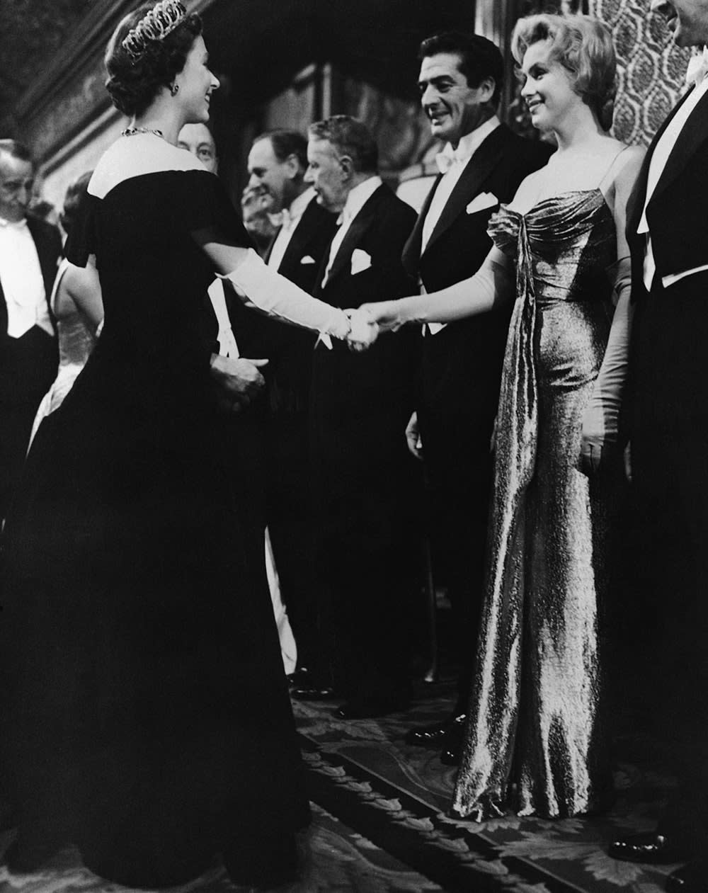 Queen Elizabeth shaking Marilyn Monroes hand.