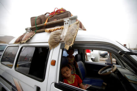 A displaced boy from Hodeidah city sleeps inside a van as they reach Sanaa, Yemen. REUTERS/Mohamed al-Sayaghi