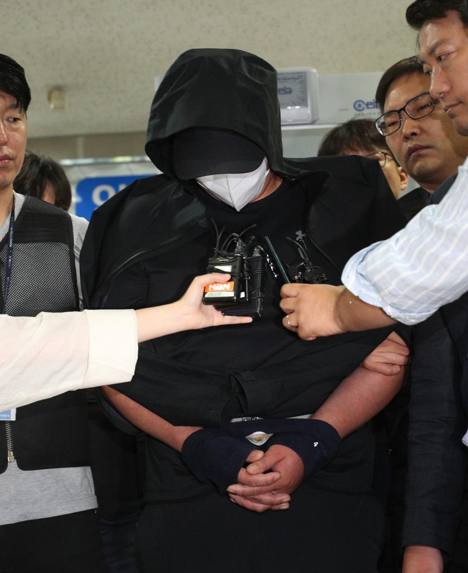 The accused of opening the emergency exit door arrives to attend an arrest warrant review at Daegu District Court (AP)