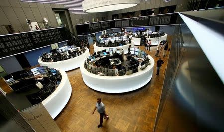 Traders work at their desks in front of the German share price index, DAX board, at the stock exchange in Frankfurt, Germany, June 24, 2016 after Britain voted to leave the European Union in the EU BREXIT referendum. REUTERS/Ralph Orlowski