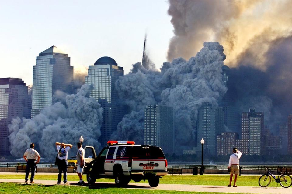 Tower 2 dissolves in a cloud of dust and debris about half an hour after the first Twin Tower collapsed (Reuters)