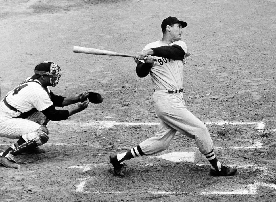 FILE - In this April 18, 1960, file photo, Ted Williams of the Boston Red Sox knocks the ball out of the park for a home run in the second inning against the Washington Senators in Washington. Growing up in the Washington suburbs during the 1960s, the local baseball team was a lost cause. So we found other things to root for under the wavy roof at D.C. Stadium and RFK. Like the time Ted Williams came to town. (AP Photo, File)