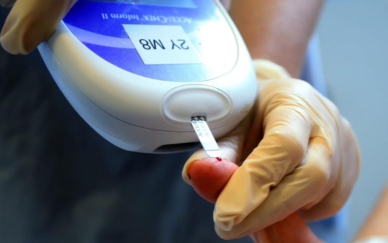 a nurse giving a patient a diabetes test - Diabetics may be forced to self-isolate at home after lockdown is lifted - PA