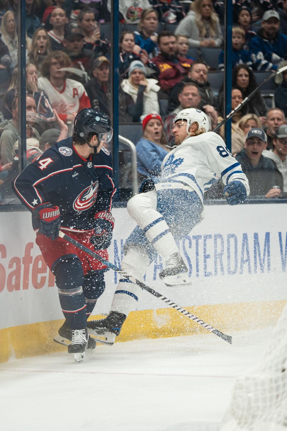 Dec 23, 2023; Columbus, Ohio, USA;
Columbus Blue Jackets center Cole Sillinger (4) crashes Toronto Maple Leafs left wing Nicholas Robertson (89) against the boards during the first period of their game on Saturday, Dec. 23, 2023 at Nationwide Arena.