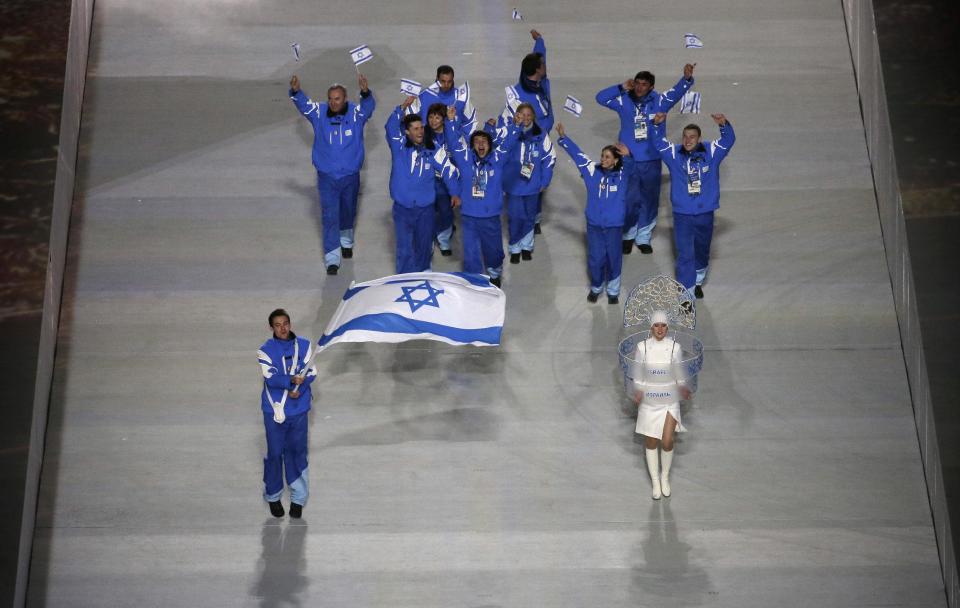 Vladislav Bykanov of Israel holds the national flag and enters the arena with his teammates during the opening ceremony of the 2014 Winter Olympics in Sochi, Russia, Friday, Feb. 7, 2014. (AP Photo/Charlie Riedel)
