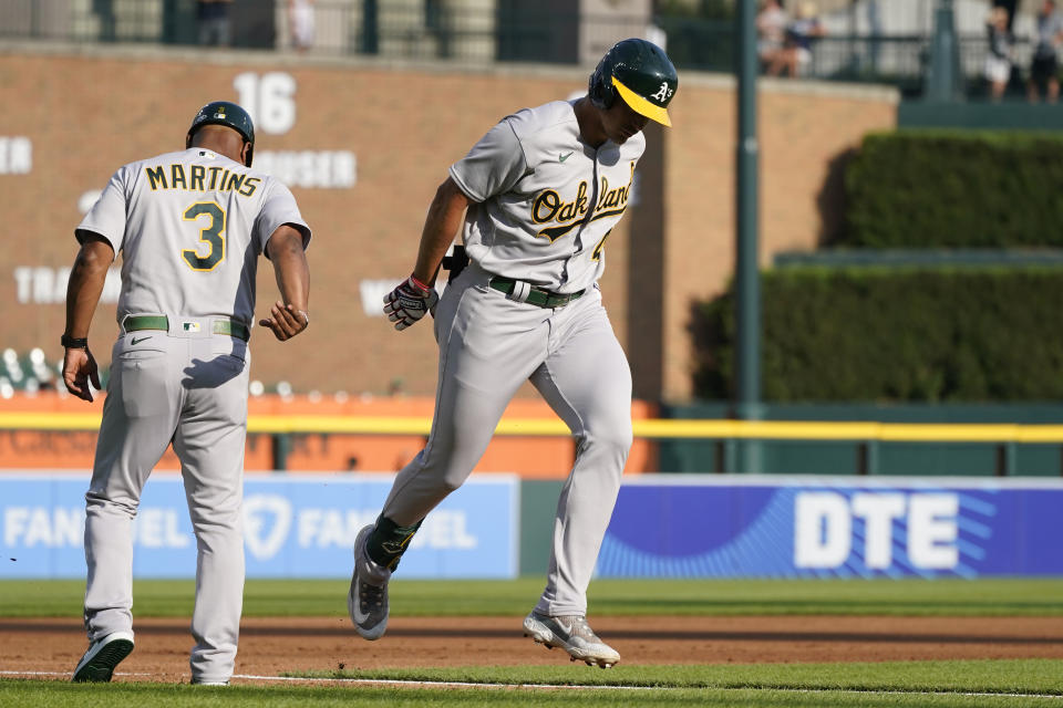 Oakland Athletics' Ryan Noda passes third base coach Eric Martins after a two-run home run during the first inning of a baseball game against the Detroit Tigers, Wednesday, July 5, 2023, in Detroit. (AP Photo/Carlos Osorio)