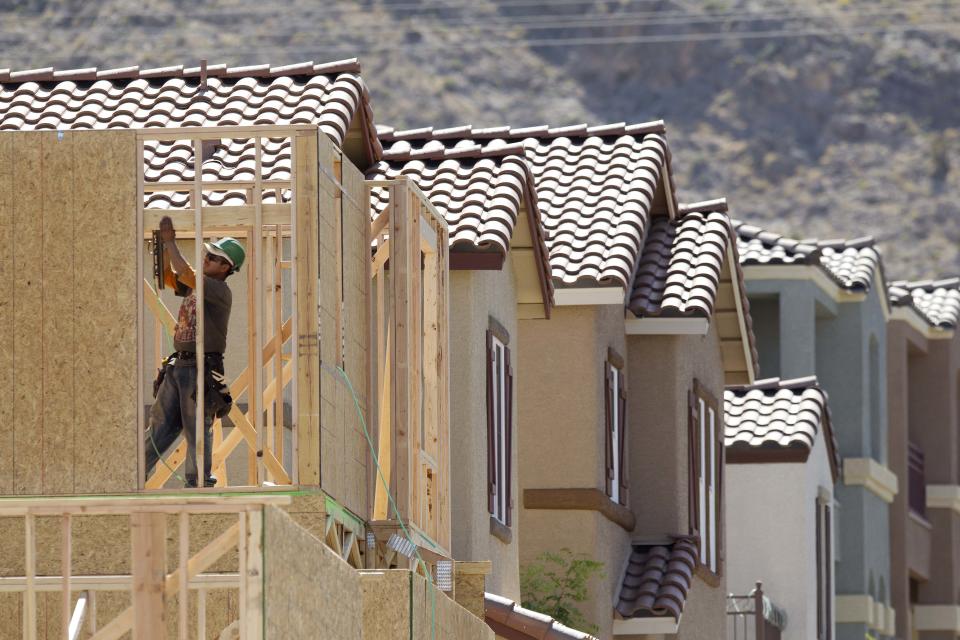 A construction worker works on the frame of a new home being built in a housing development on the west edge of town in Las Vegas.  (Credit: Julie Jacobson, AP Photo)