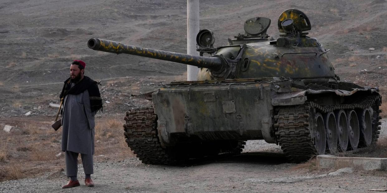 A Taliban soldier in front of an old Soviet tank, February 2022.