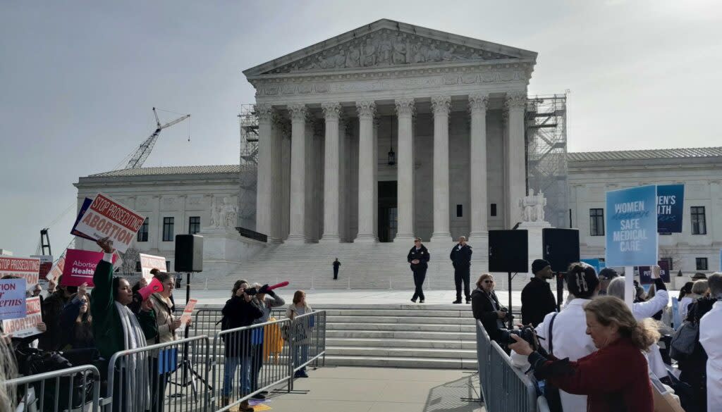 Protestors are separated by fencing at the U.S. Supreme Court building