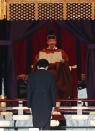 Japan's Emperor Naruhito speaks as Prime Minister Shinzo Abe is seen during a ceremony to proclaim his enthronement to the world, called Sokuirei-Seiden-no-gi, at the Imperial Palace in Tokyo, Japan, Tuesday, Oct. 22, 2019. (Issei Kato/Pool Photo via AP)