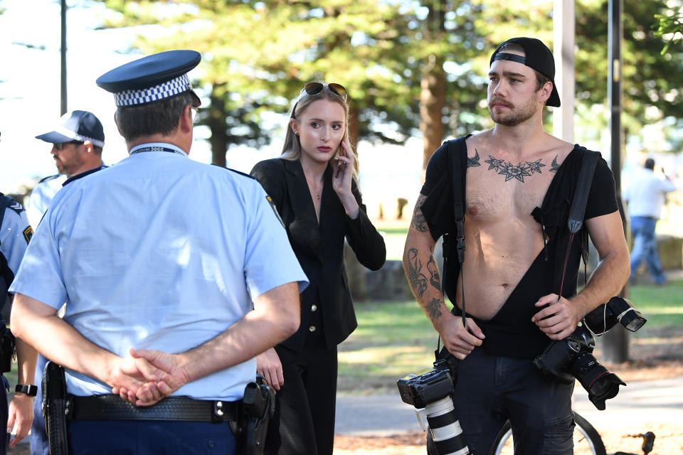 NewsCorp photographer Dylan Robinson (right) and reporter Eliza Barr (centre) are seen after a confrontation with a member of the public following a press conference with Senator Fraser Anning at Dunningham Park at Cronulla in Sydney, Friday, April 25, 2019. (AAP Image/Joel Carrett) NO ARCHIVING