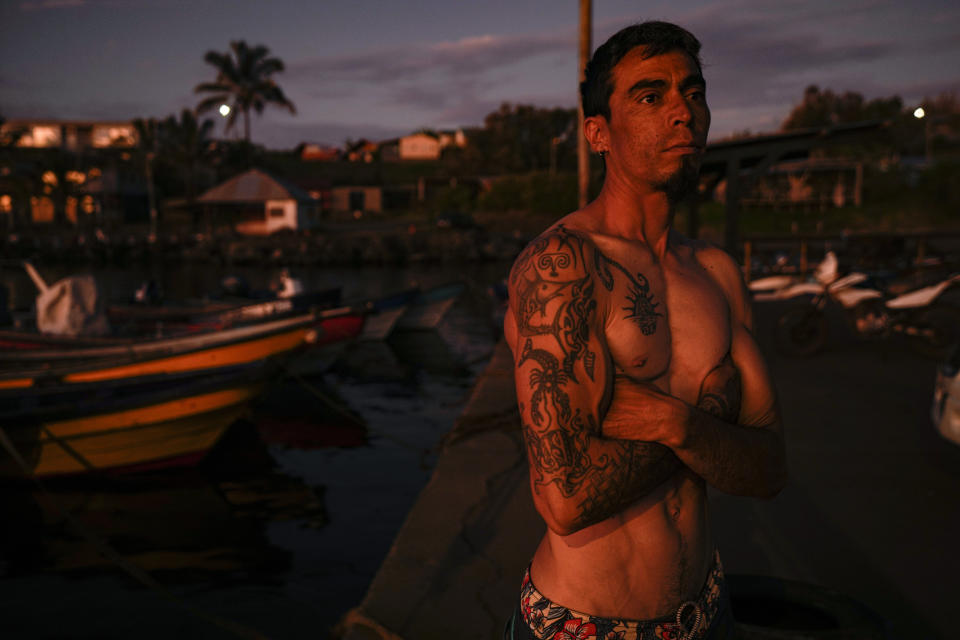 Fisherman Christopher Teao stands in the fishermen's cove after a day of fishing in Hanga Roa, Rapa Nui, or Easter Island, Chile, Friday, Nov. 25, 2022. Home to about 7,700 people – about half of them with Rapanui ancestry -- Rapa Nui is one of the world's most isolated inhabited islands. (AP Photo/Esteban Felix)