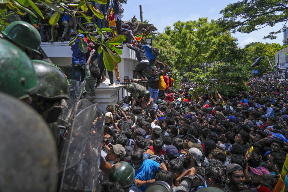 Protesters storm the Sri Lankan Prime Minister Ranil Wickremesinghe's office, demanding he resign after president Gotabaya Rajapaksa fled the country amid economic crisis in Colombo, Sri Lanka, Wednesday, July 13, 2022. Sri Lanka’s president fled the country without stepping down Wednesday, plunging a country already reeling from economic chaos into more political turmoil. Protesters demanding a change in leadership then trained their ire on the prime minister and stormed his office. (AP Photo/ Photo/Rafiq Maqbool)