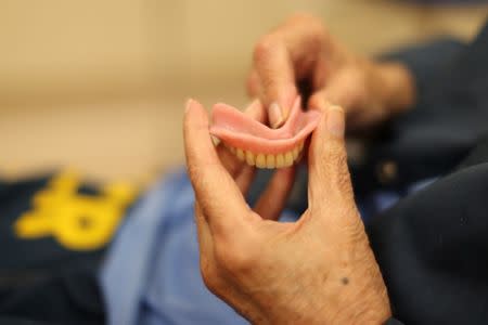 Louis Henson, 74, has his dentures fixed at the California Health Care Facility in Stockton, California, U.S., May 24, 2018. REUTERS/Lucy Nicholson